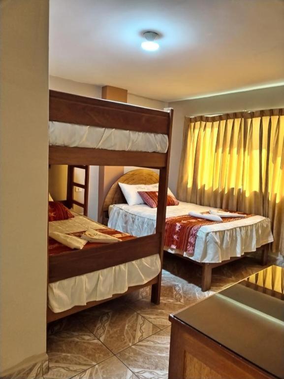 Postel nebo postele na pokoji v ubytování Hotel Colquewasi