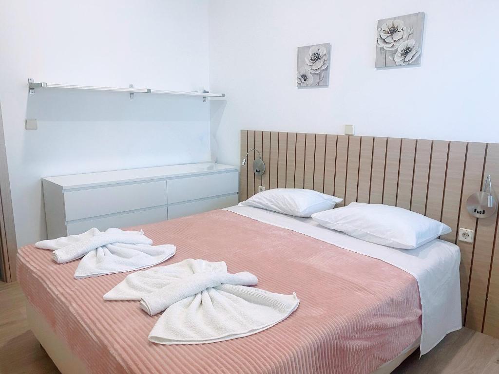 a bedroom with a bed with towels on it at MariAggela's Cosy House in Theologos