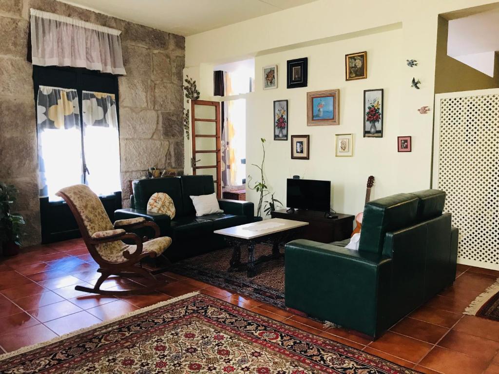 a living room with couches and a table and chairs at Casa Bella para peregrinos- Charm House for pilgrims in A Guarda