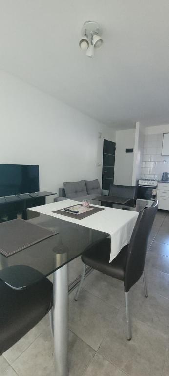a dining room with a table and two chairs at Departamento familiar in Caleta Olivia