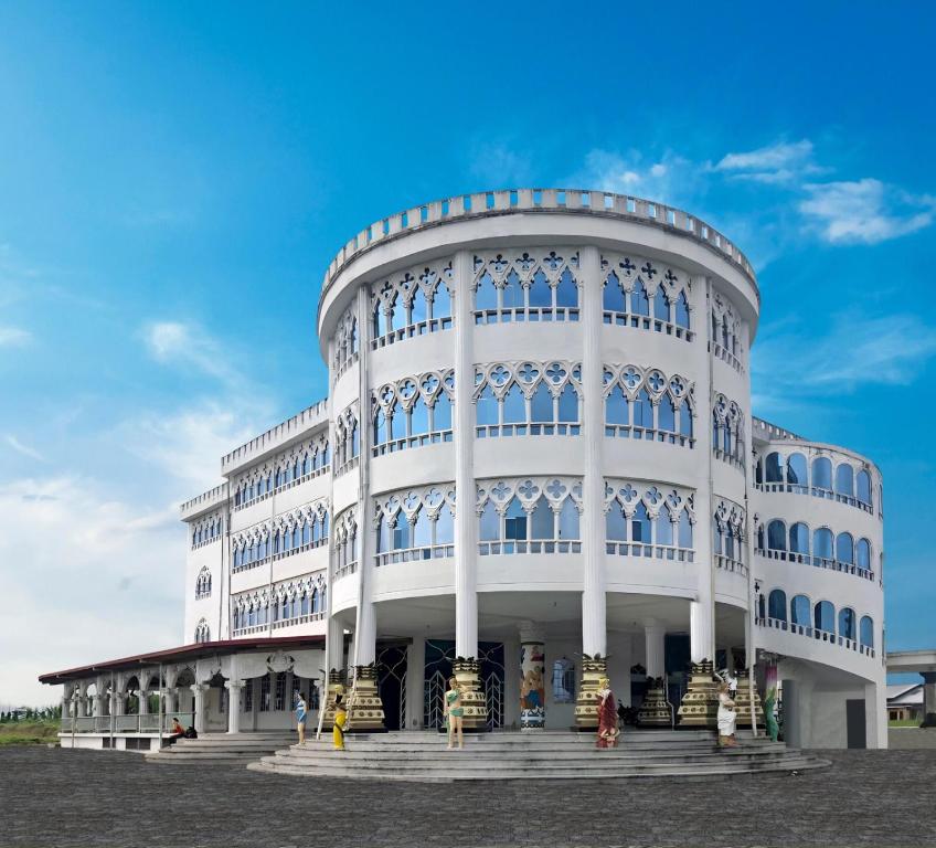 a white building with a blue sky in the background at Hotel Palace in La Concordia