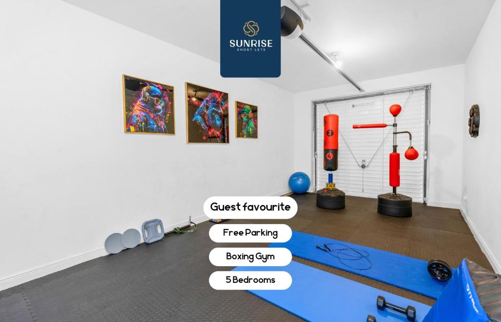 a room with a gym with signs on the wall at Friary Townhouse - INVOICE and REDUCED PRICE only via SUNRISE SHORT LETS DUNDEE, 5 Double Bedrooms, 4 Bathrooms, GYM, GAMES, GARDEN, Fully Equipped, Free Parking, Central Location, Contractors and Trades People Favourite in Dundee