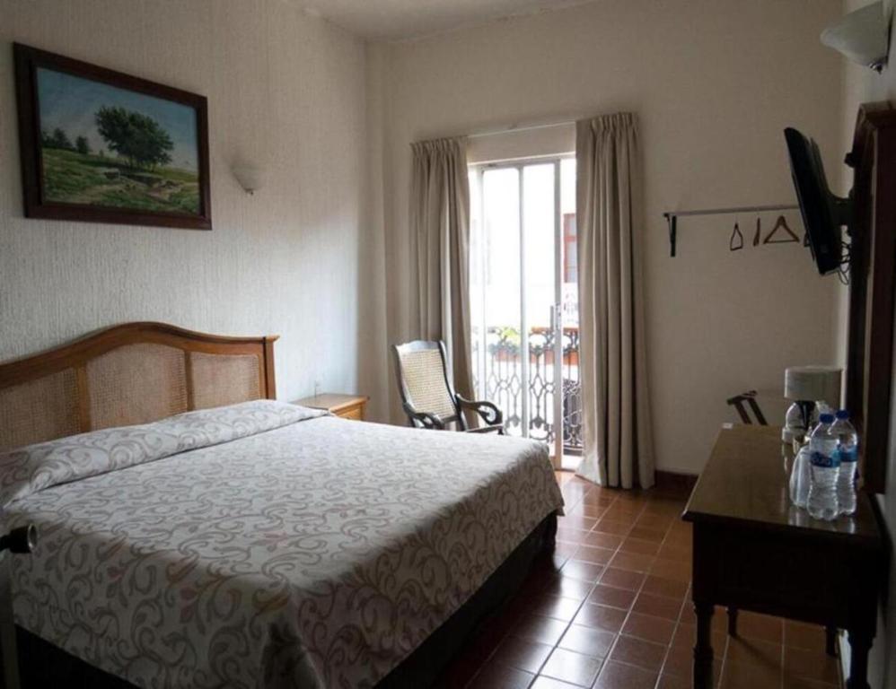 Postel nebo postele na pokoji v ubytování Hotel Posada Doña Lala