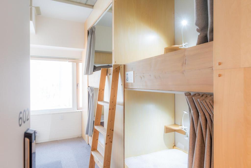 Postel nebo postele na pokoji v ubytování Grand Hostel LDK Sapporo
