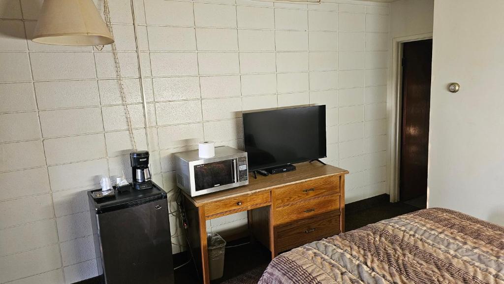 Postel nebo postele na pokoji v ubytování Camelot Court Motel