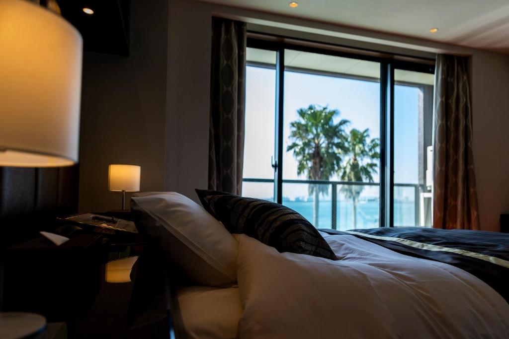 Postel nebo postele na pokoji v ubytování Hotel MYTH-L&A-ホテル マイス エルアンドエー