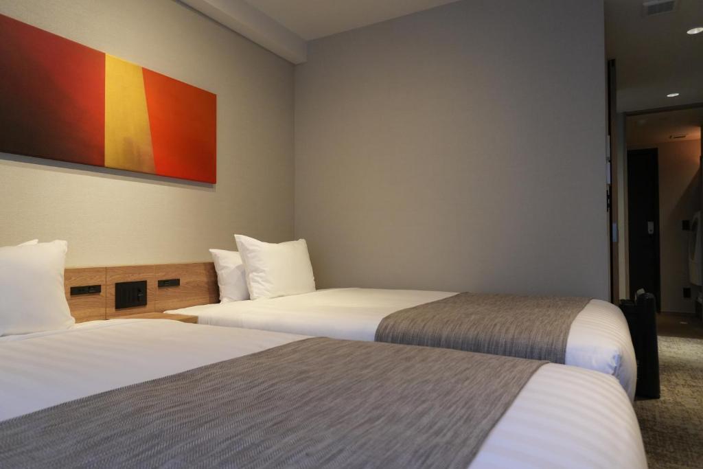 Postel nebo postele na pokoji v ubytování Premium Apart MONday GINZA EAST