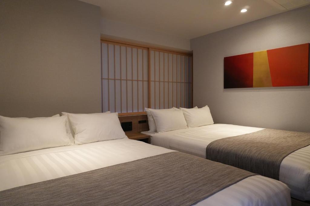Postel nebo postele na pokoji v ubytování Premium Apart MONday GINZA EAST
