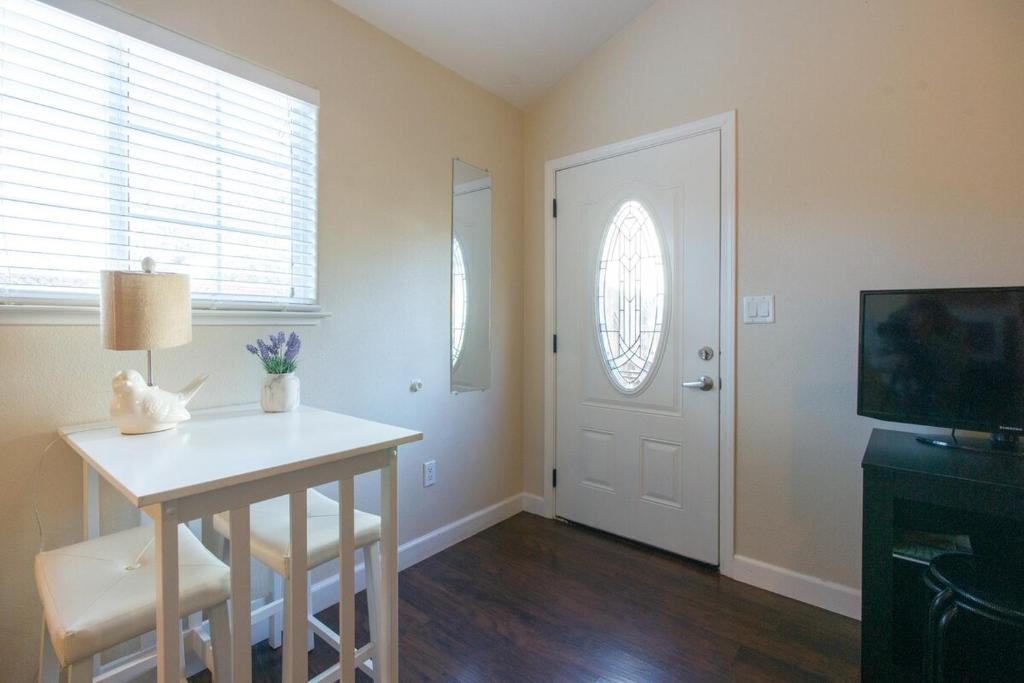 a room with a table and a television and a door at Sonoma Getaway for Two - Great Location in Sonoma