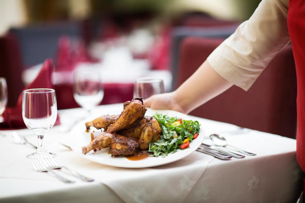 a person sitting at a table with a plate of food at Gateway Hotel in Dubai