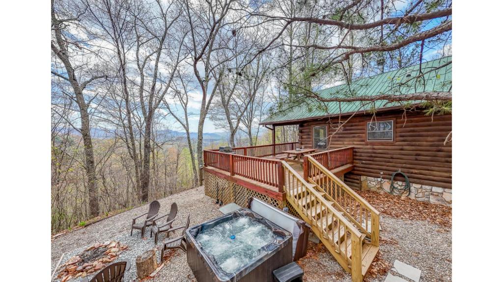a cabin with a hot tub and a deck at Dream Circle in Bryson City