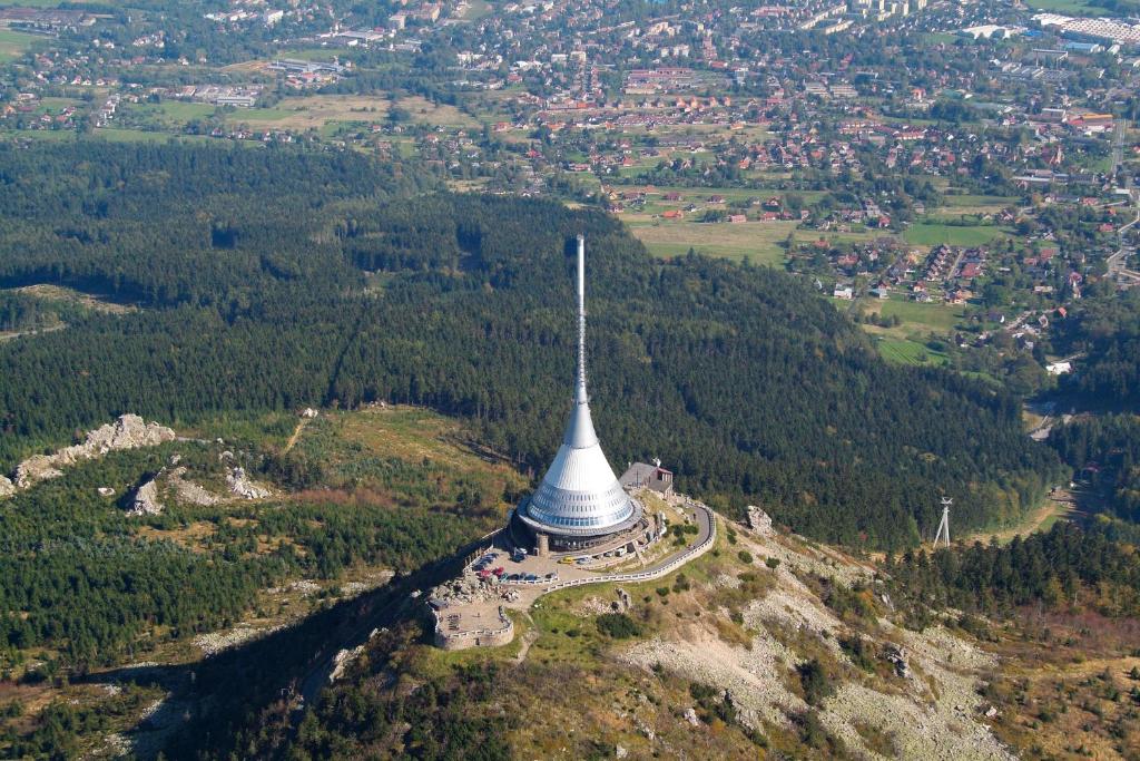an aerial view of a tower on top of a mountain at Hotel Ještěd in Liberec
