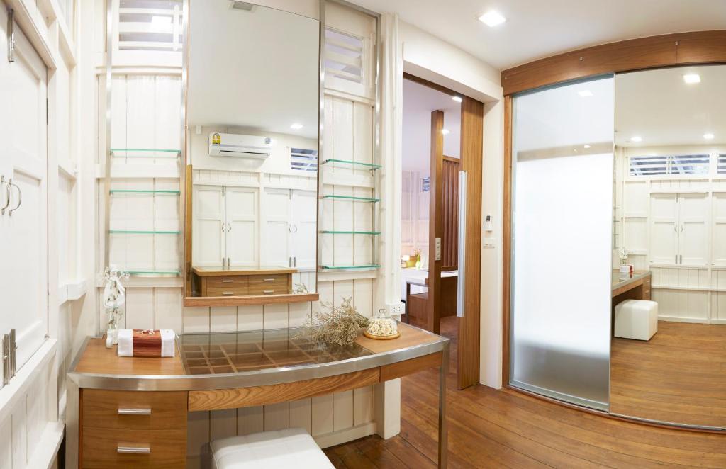a bathroom with a sink and a mirror at Uncle Loy's Boutique House in Bangkok