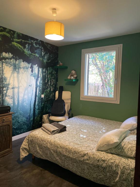 a bedroom with a bed with a large painting on the wall at Zen house with a view in Manosque