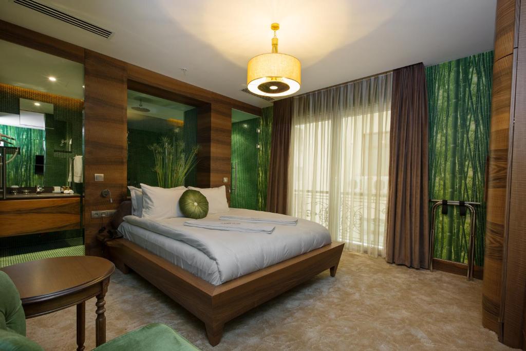 a bedroom with a bed and a table and a window at Golden Pars Hotel in Bursa