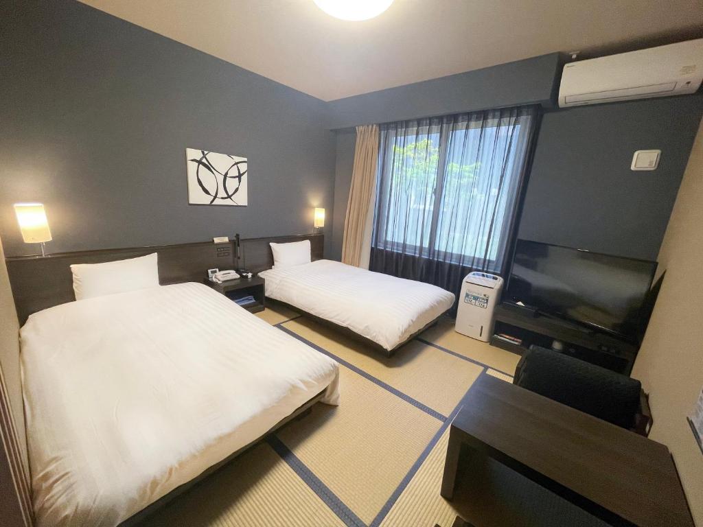 Postel nebo postele na pokoji v ubytování Hotel Route Inn Ise