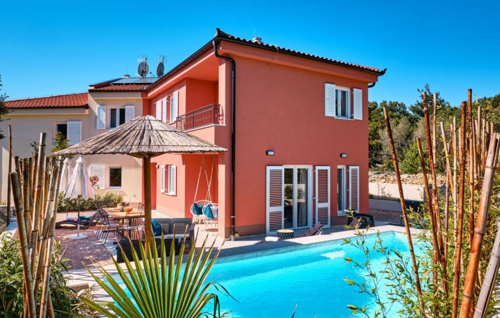 a villa with a swimming pool in front of a house at Villa Miholascica 1 on Island Cres by Villas Guide in Cres