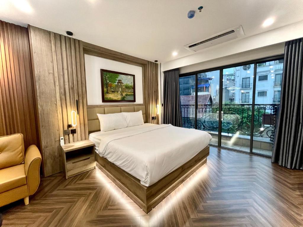 En eller flere senge i et værelse på G-Apartment & Hotel