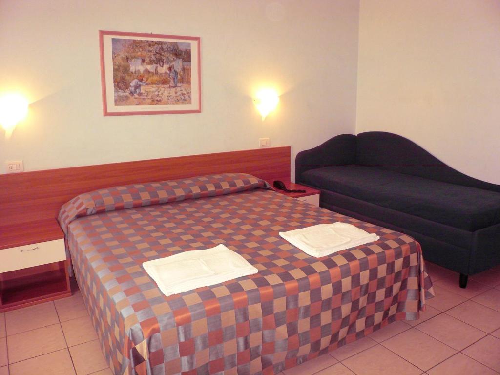 Postel nebo postele na pokoji v ubytování Hotel Iones