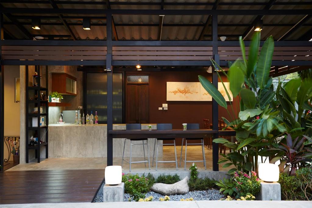 a dining room with a table and some plants at Uncle Loy's Boutique House in Bangkok
