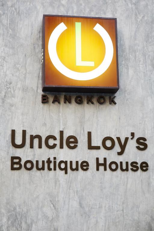 a sign on the side of a building at Uncle Loy's Boutique House in Bangkok