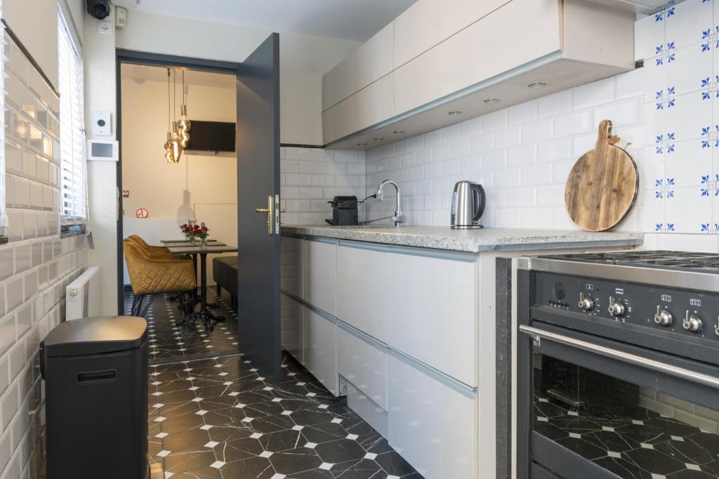 a kitchen with a stove and a counter top at Petite Room With Wifi, Ac, And Shared Kitchen in Tilburg