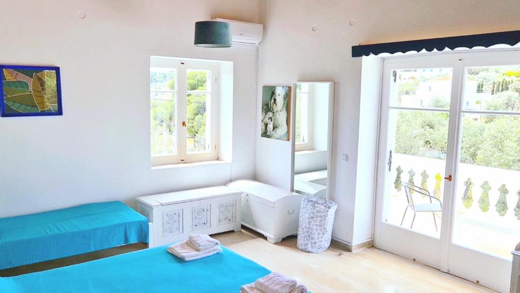 a room with a blue bed and a window at Greek paradise Spetses in Spetses