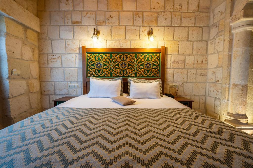 Postel nebo postele na pokoji v ubytování Cappadocia Sweet Cave