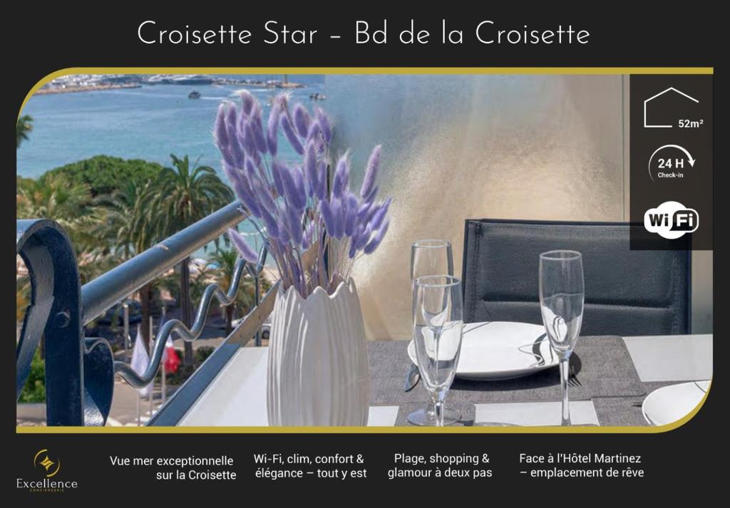 un vase avec des fleurs violettes posé sur une table avec des verres dans l'établissement Croisette Star - Bd Croisette, à Cannes