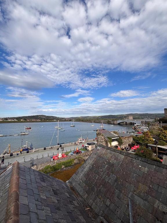 a view of a harbor with boats in the water at Stylish Coastal Apartment with Breathtaking views in Conwy
