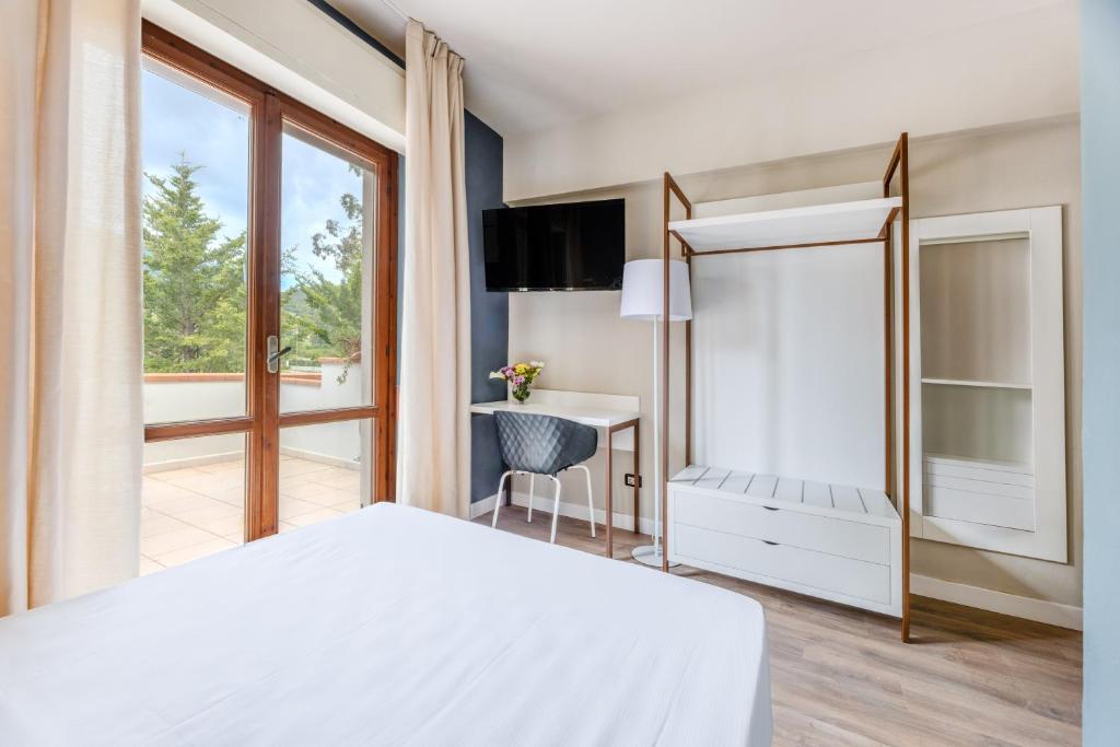 Postel nebo postele na pokoji v ubytování Elba Vibe Smart Hotel