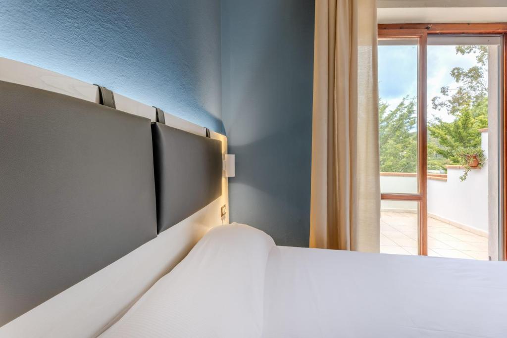 Postel nebo postele na pokoji v ubytování Elba Vibe Smart Hotel