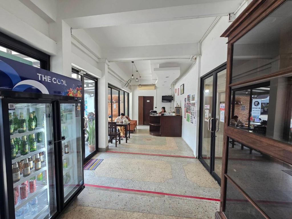 A view down the hotel lobby shows the drinks cooler, display cabinet, seating and reception counter.