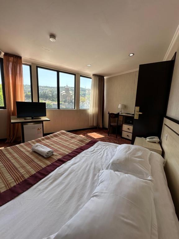 Postel nebo postele na pokoji v ubytování Hotel Beka Palace