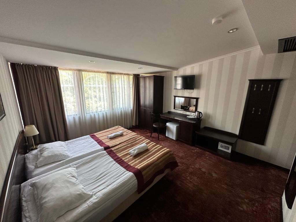 Postel nebo postele na pokoji v ubytování Hotel Beka Palace