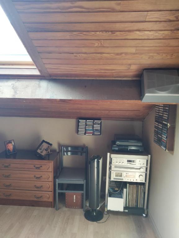 une chambre mansardée avec un bureau et un bureau dans l'établissement Chambres chez l'habitant, à Valréas