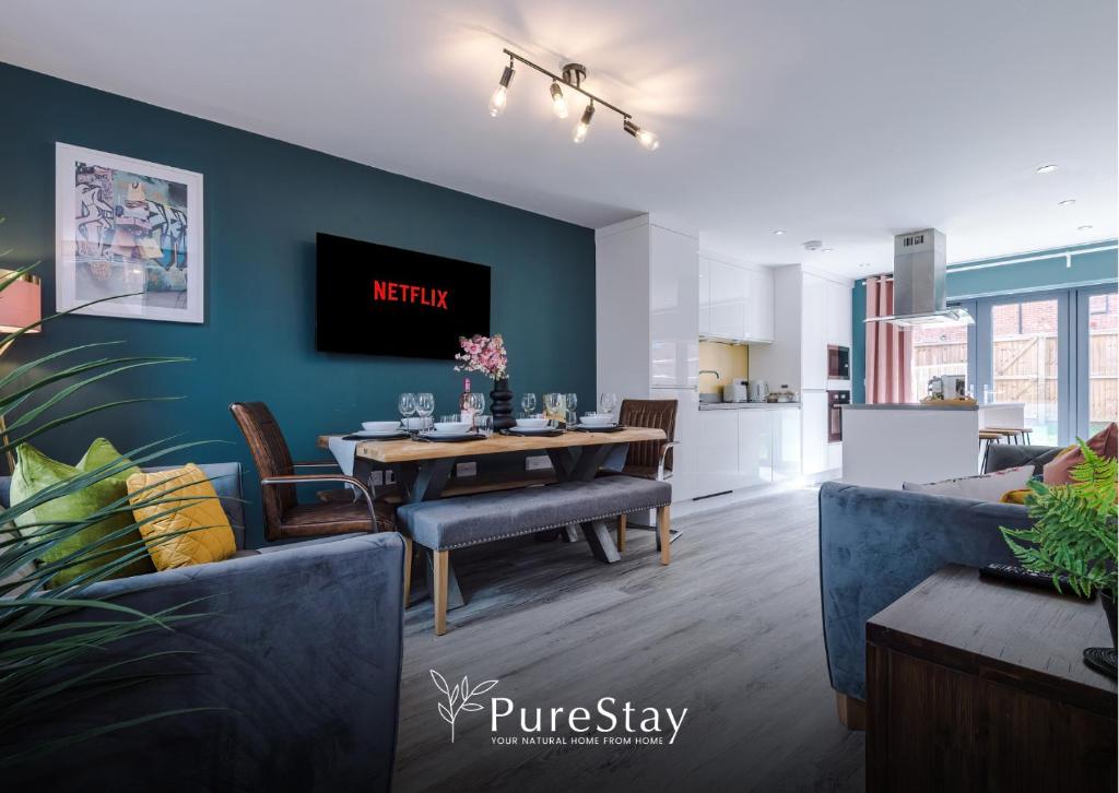 a dining room and living room with a dining table at Modern 5 Bedroom House in Manchester by PureStay - Short Stay with Service Accommodation & Free Parking in Manchester