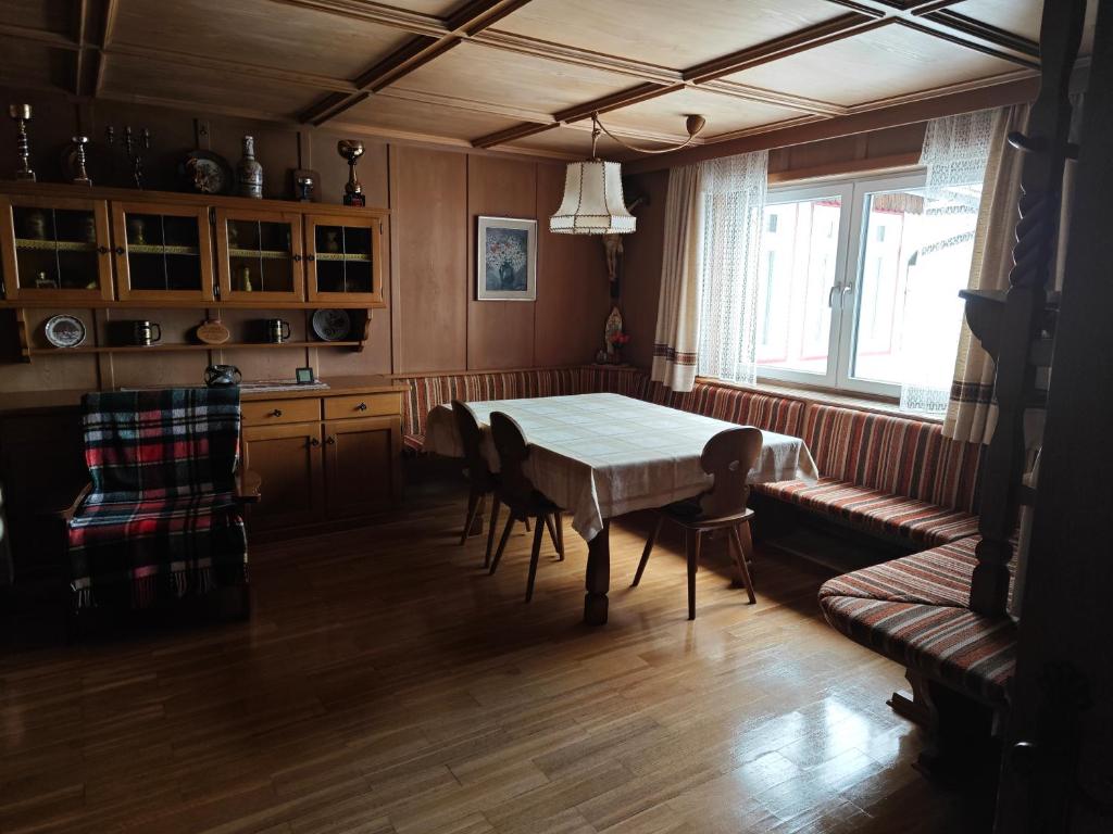 a dining room with a table and chairs and a window at Casa Rizzi in Campitello di Fassa