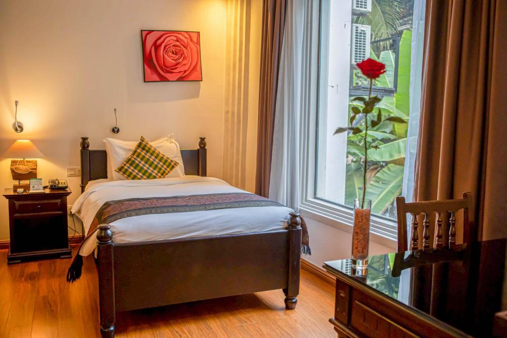 Postel nebo postele na pokoji v ubytování La Rose Suites