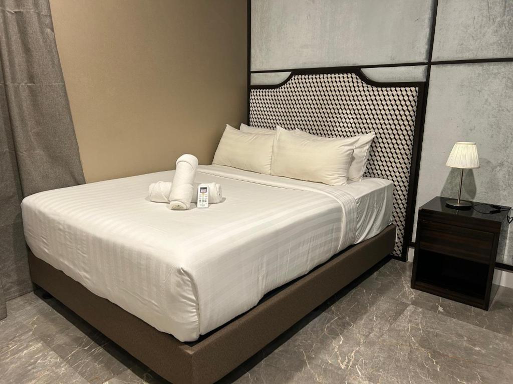 a bedroom with a bed with a teddy bear on it at KSM GLOBAL APARTMENT At TIMES SQUARE kl in Kuala Lumpur