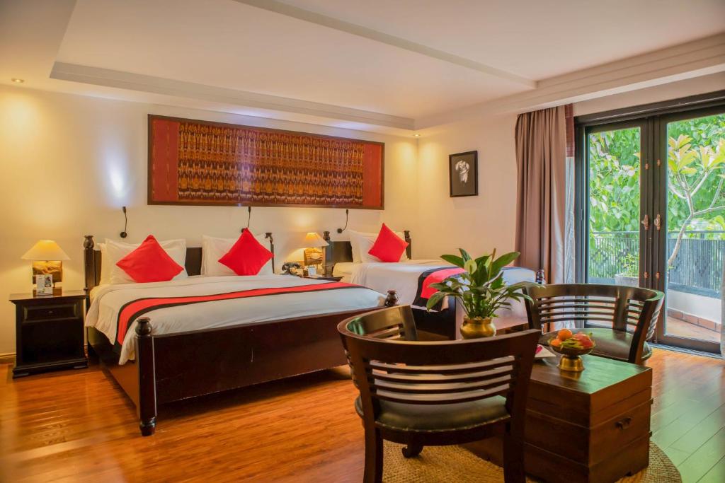 Postel nebo postele na pokoji v ubytování La Rose Suites