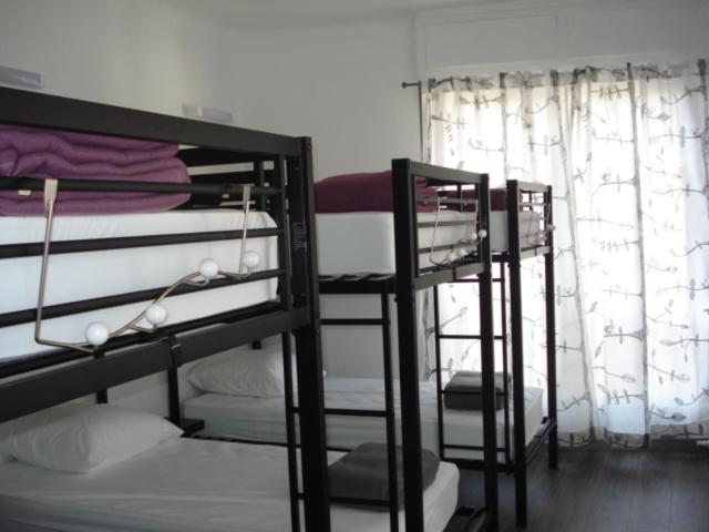 a bedroom with two bunk beds and a window at Gite Izaxulo in Saint-Jean-Pied-de-Port