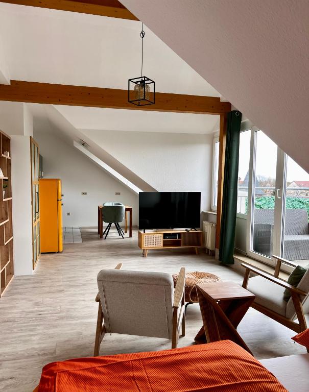 a living room with a tv and a couch at City-View Studio with Balcony, Dessau in Dessau