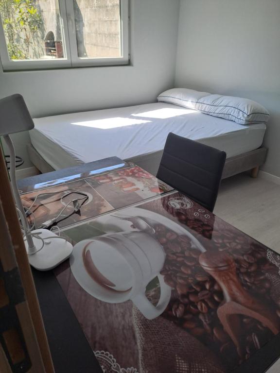 a bedroom with a desk and a bed and a table at Calme Room in Mitry-Mory