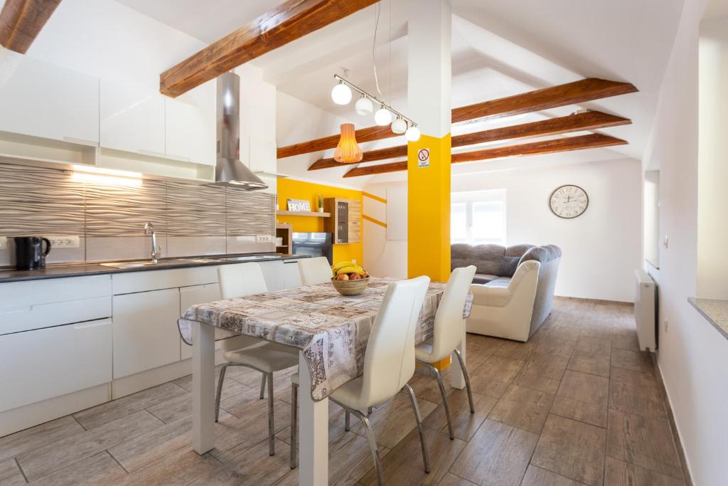 a kitchen and dining room with a table and chairs at Apartma Majdas in Loka pri Mengšu