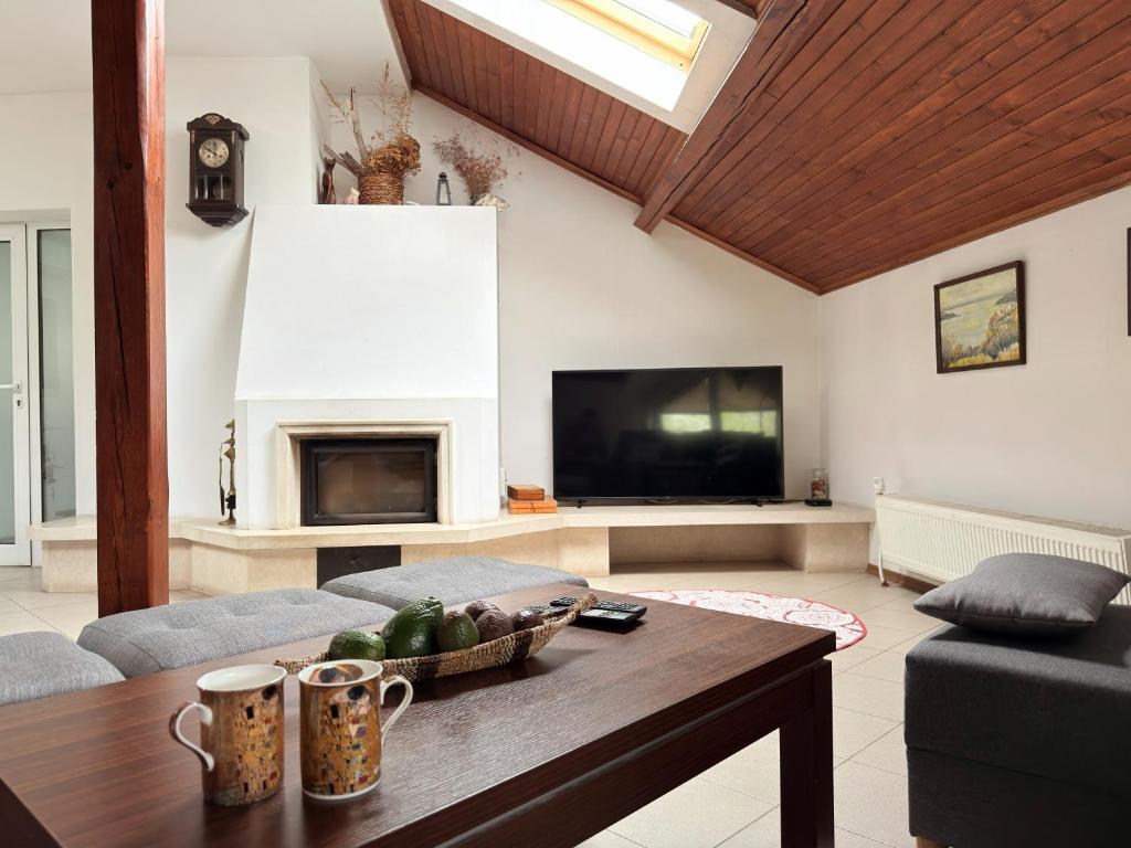a living room with a couch and a table and a tv at Corner house apartment in Montana