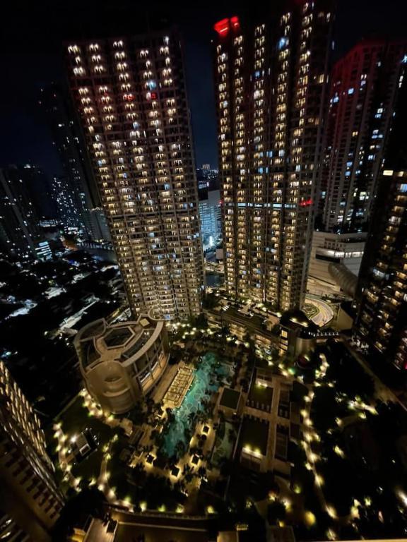 a view of a city at night with tall buildings at Premium Taman Anggrek Residences in Jakarta