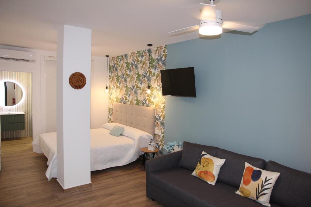 a living room with a couch and a bed at Ruzafa Acquamarina in Valencia