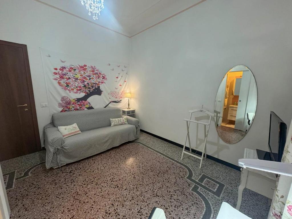 a living room with a couch and a mirror at Luxury Penthouse 50m from the Sea, near the Center in Savona