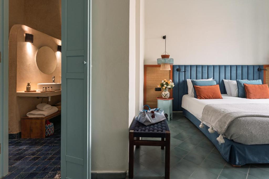 a bedroom with a bed and a table with shoes on it at Le Palazzo in Essaouira
